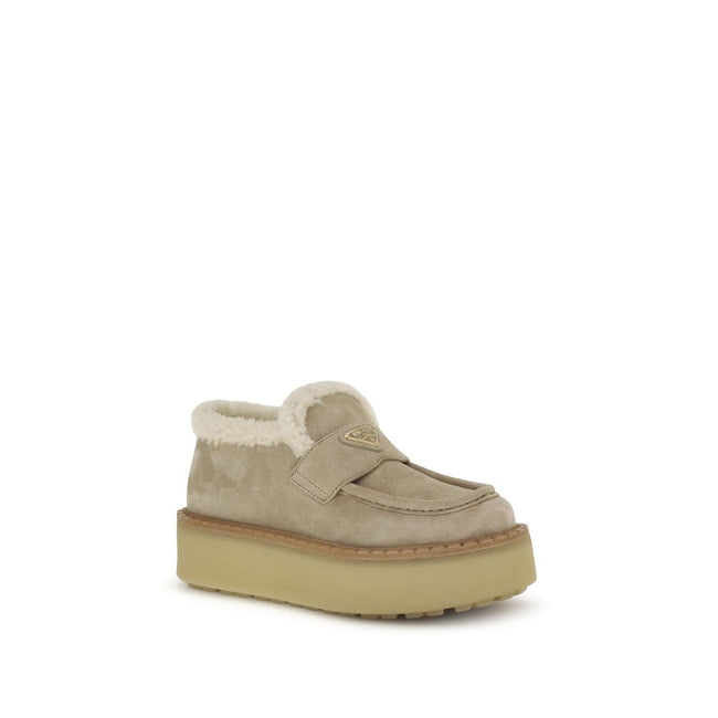 Beige Calf Leather Bos Taurus Platform LoafersSuede Loafers by Prada combine comfort and style in a bold design. Featuring a platform sole and round toe, they feature a soft shearling-lined interior for a snug fit. The upper tray is embellished with the i