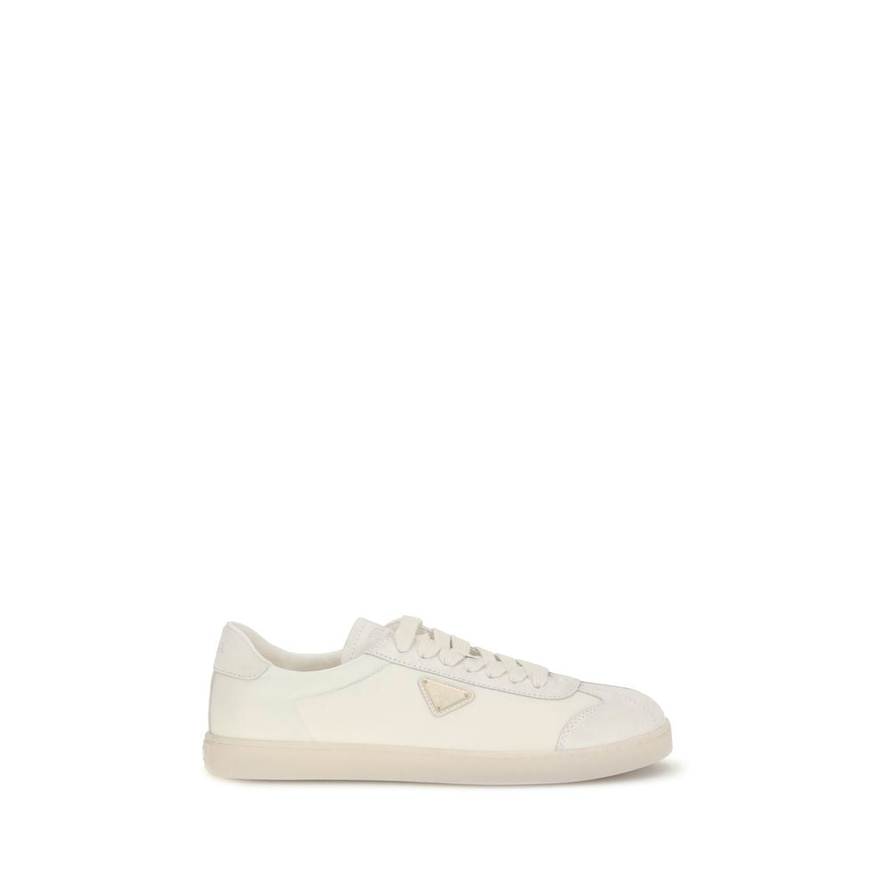 Cream Leather Low Top SneakersLeather Sneakers by Prada combine contemporary style with everyday comfort. Featuring a flat rubber sole and round toe, they are distinguished by the iconic triangular side-applied plaque and tone-on-tone logo on the back, ad