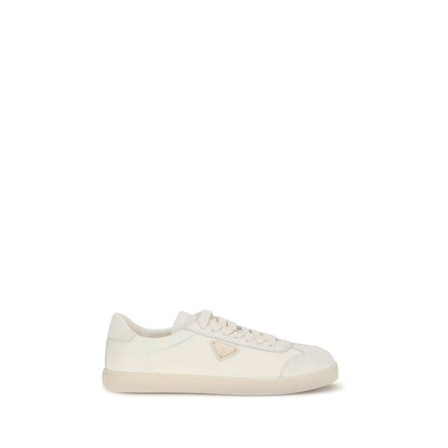 Cream Leather Low Top SneakersLeather Sneakers by Prada combine contemporary style with everyday comfort. Featuring a flat rubber sole and round toe, they are distinguished by the iconic triangular side-applied plaque and tone-on-tone logo on the back, ad