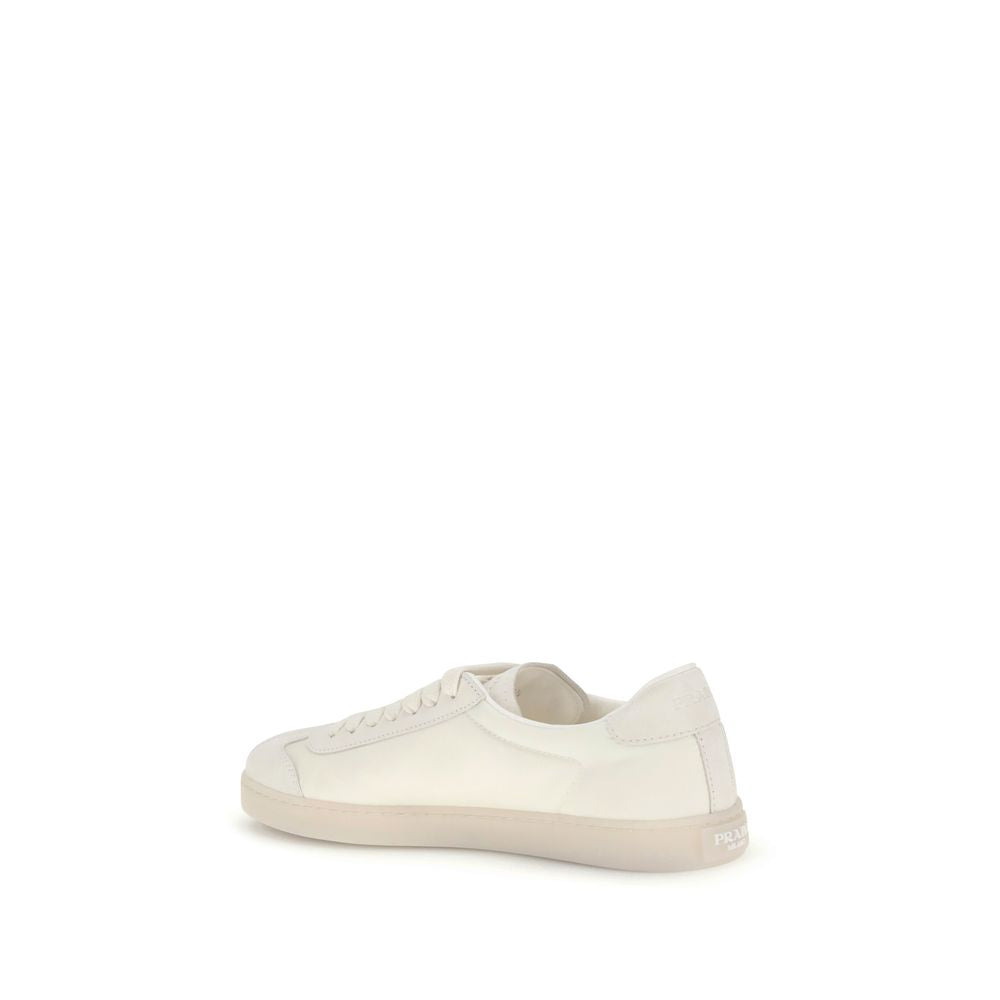 Cream Leather Low Top SneakersLeather Sneakers by Prada combine contemporary style with everyday comfort. Featuring a flat rubber sole and round toe, they are distinguished by the iconic triangular side-applied plaque and tone-on-tone logo on the back, ad