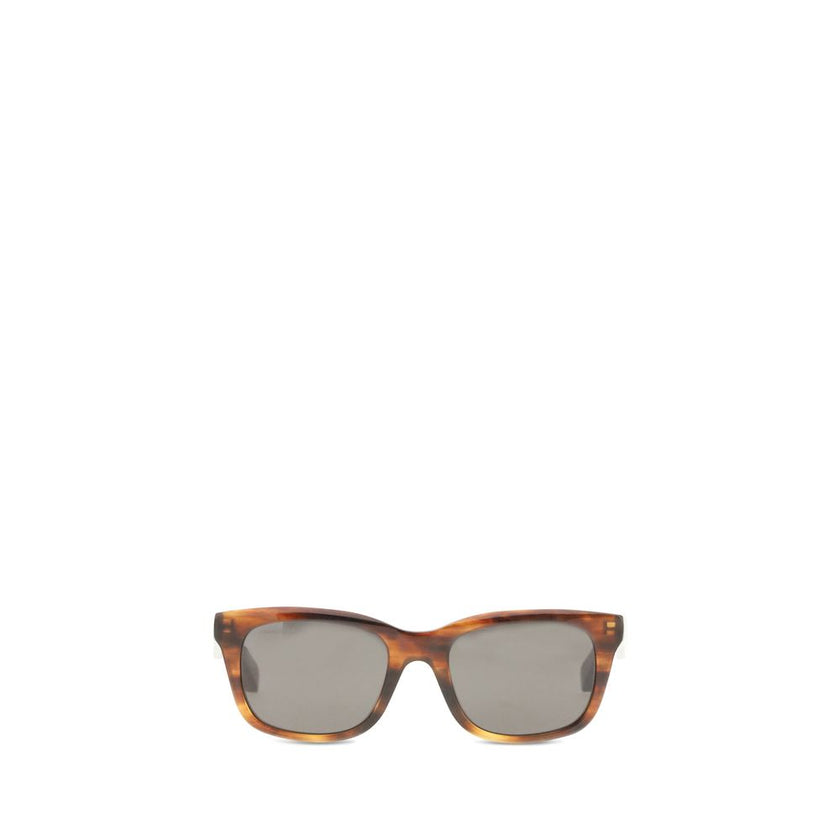 Brown Acetate SunglassesSunglasses by Balenciaga are made of acetate and feature a square, modern and distinctive shape. On the side is the brand’s signature, a detail that emphasizes its exclusivity. The lenses are made of Bio-Nylon, an innovative materi