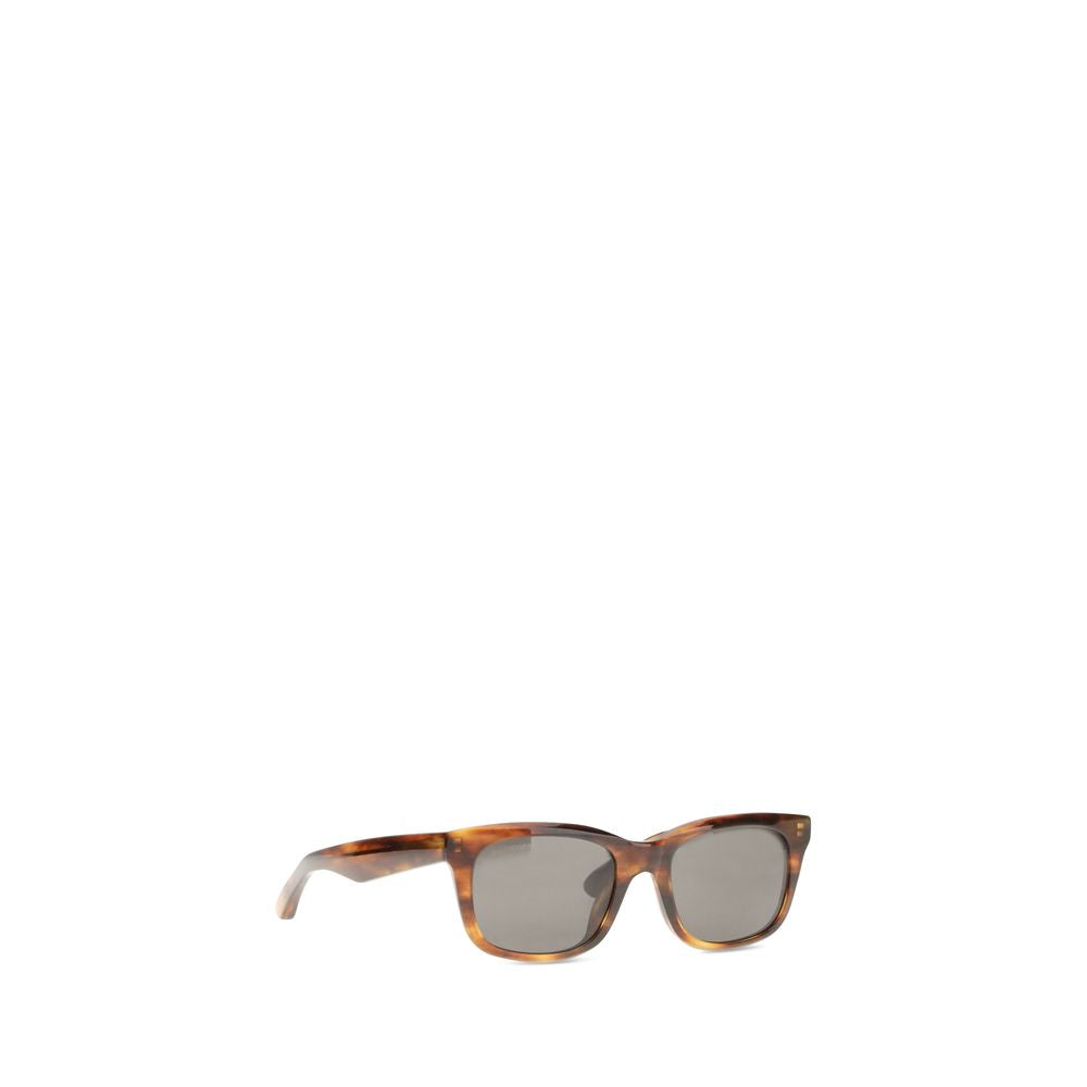 Brown Acetate SunglassesSunglasses by Balenciaga are made of acetate and feature a square, modern and distinctive shape. On the side is the brand’s signature, a detail that emphasizes its exclusivity. The lenses are made of Bio-Nylon, an innovative materi