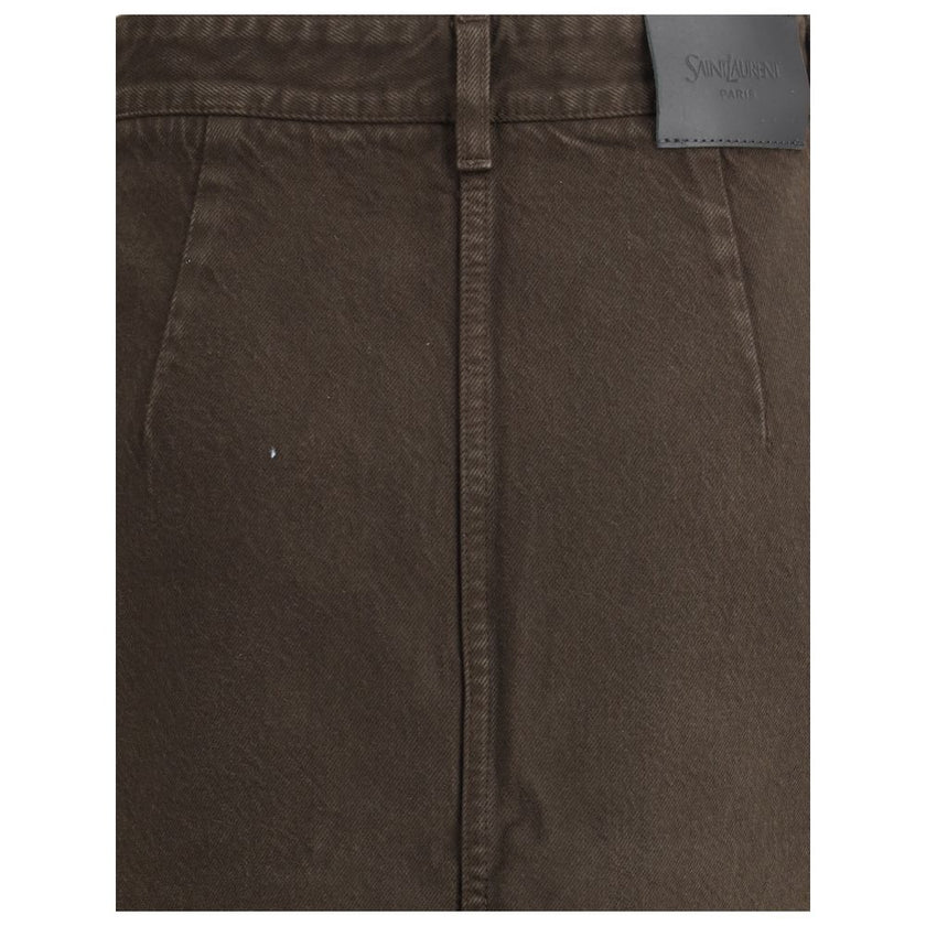 Brown Denim SkirtThe Denim Pencil Skirt by Saint Laurent combines practicality with contemporary style in an essential piece. Crafted from certified cotton, it features a mid-rise waist with belt loops, a back vent for ease of movement, and a fitted silho