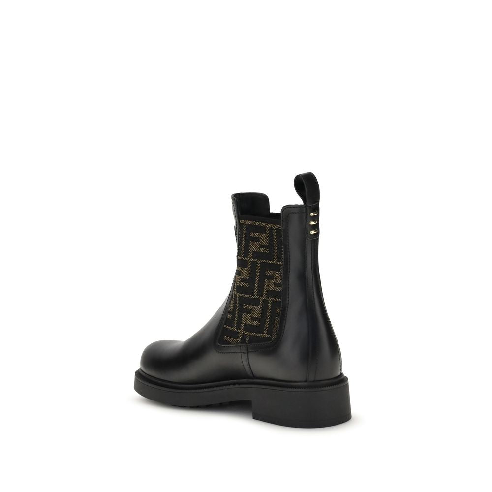 FF leather and fabric Ankle BootsFF leather and fabric Ankle Boots by Fendi combine urban style with iconic details. Made of black leather with elastic side inserts, they feature fabric details with the unmistakable FF motif. The back is embellished with