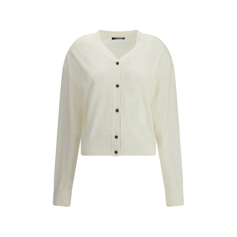 White Merino Wool CardiganMerino wool Cardigan by Jacquemus combines elegance and comfort with a V-neckline and front button closure. Finished with a ribbed hem and cuffs, it is embellished with an embroidered logo on the back for a distinctive, modern to