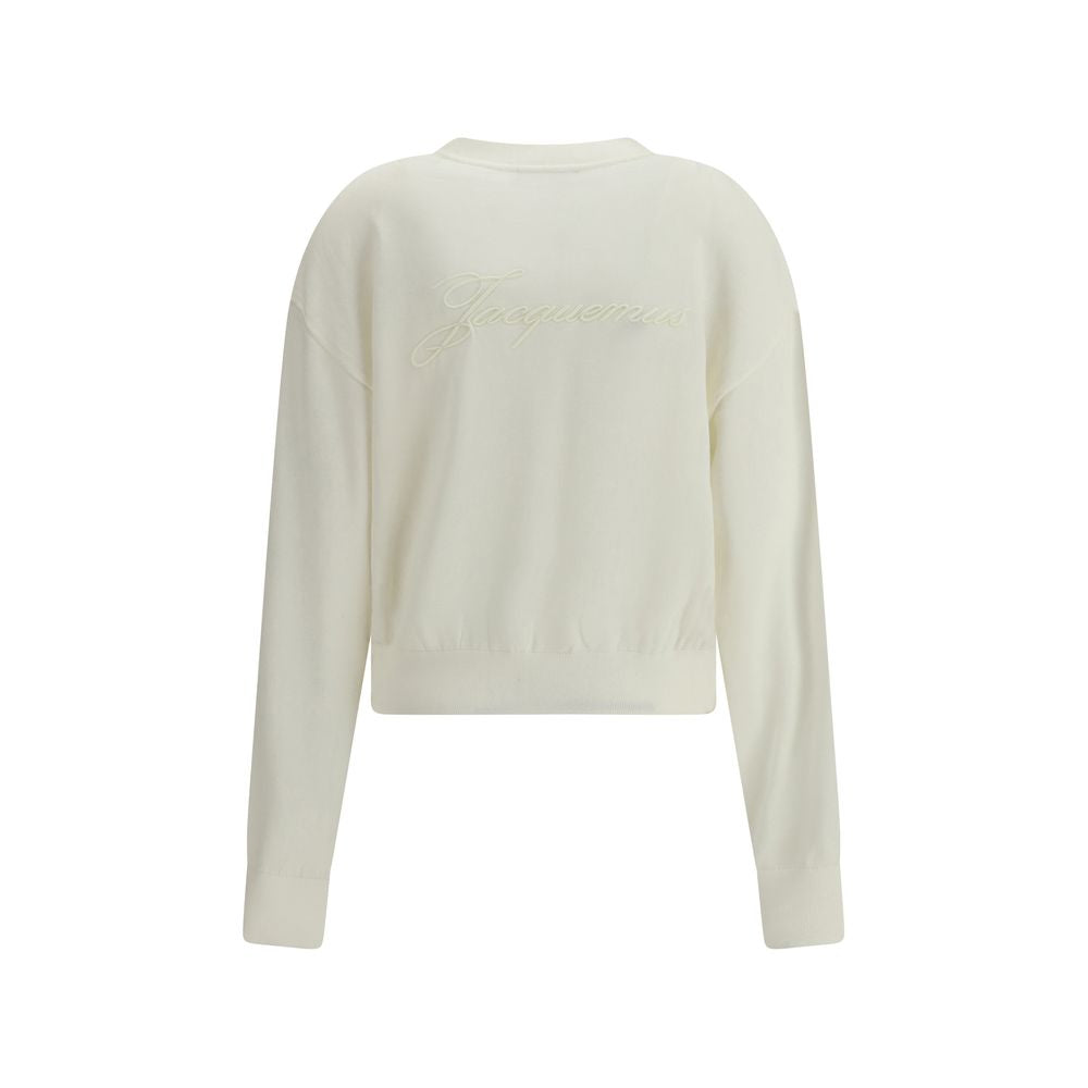White Merino Wool CardiganMerino wool Cardigan by Jacquemus combines elegance and comfort with a V-neckline and front button closure. Finished with a ribbed hem and cuffs, it is embellished with an embroidered logo on the back for a distinctive, modern to