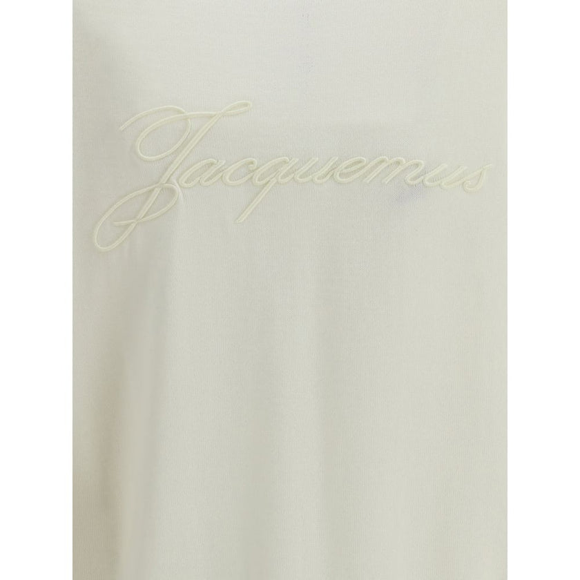 White Merino Wool CardiganMerino wool Cardigan by Jacquemus combines elegance and comfort with a V-neckline and front button closure. Finished with a ribbed hem and cuffs, it is embellished with an embroidered logo on the back for a distinctive, modern to