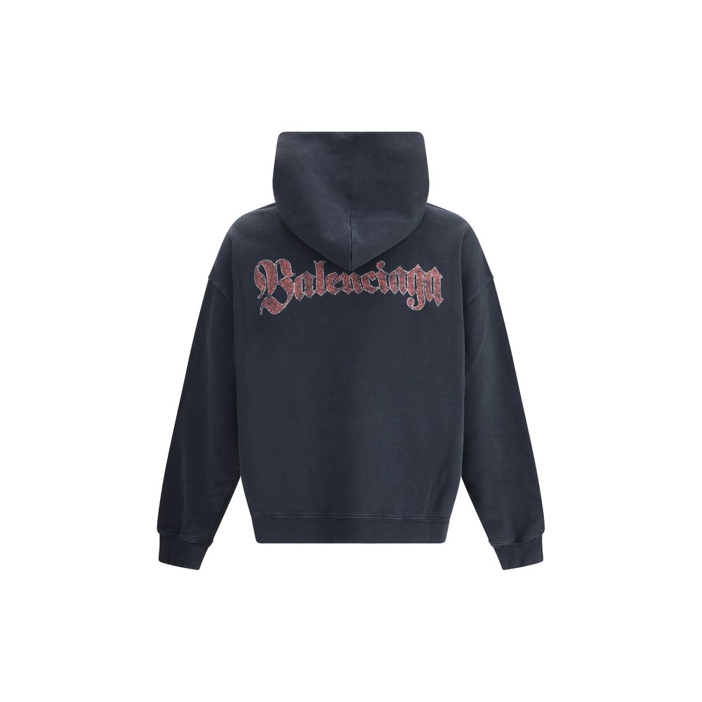 Black Cotton SweatshirtThe Spiral Crest Hoodie by Balenciaga in dry fleece redefines streetwear with a bold graphic accent. Designed with a medium fit, it features a hood without drawstrings, relaxed shoulders, and a front kangaroo pocket. The gathered cu