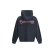 Black Cotton SweatshirtThe Spiral Crest Hoodie by Balenciaga in dry fleece redefines streetwear with a bold graphic accent. Designed with a medium fit, it features a hood without drawstrings, relaxed shoulders, and a front kangaroo pocket. The gathered cu
