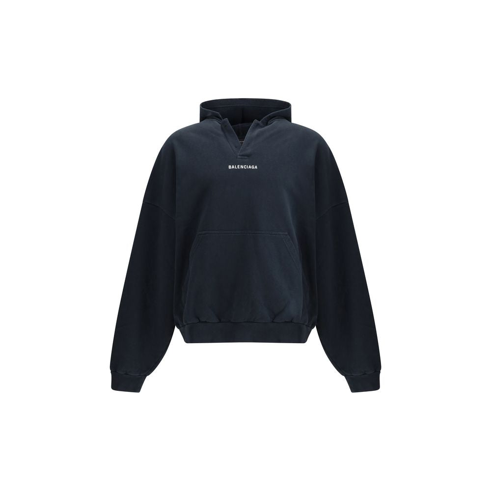 Black Cotton SweatshirtThe Hoodie by Balenciaga blends comfort with iconic design. Crafted from medium fleece, it features a relaxed silhouette with dropped shoulders and a functional kangaroo pocket. Elasticated cuffs and hem ensure a defined fit, while
