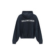Black Cotton SweatshirtThe Hoodie by Balenciaga blends comfort with iconic design. Crafted from medium fleece, it features a relaxed silhouette with dropped shoulders and a functional kangaroo pocket. Elasticated cuffs and hem ensure a defined fit, while