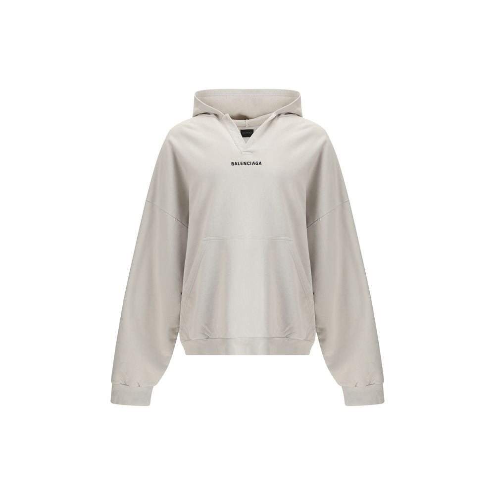White Cotton SweatshirtThe Hoodie by Balenciaga blends comfort with iconic design. Crafted from medium fleece, it features a relaxed silhouette with dropped shoulders and a functional kangaroo pocket. Elasticated cuffs and hem ensure a defined fit, while