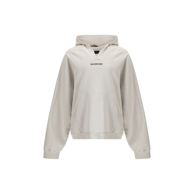 White Cotton SweatshirtThe Hoodie by Balenciaga blends comfort with iconic design. Crafted from medium fleece, it features a relaxed silhouette with dropped shoulders and a functional kangaroo pocket. Elasticated cuffs and hem ensure a defined fit, while
