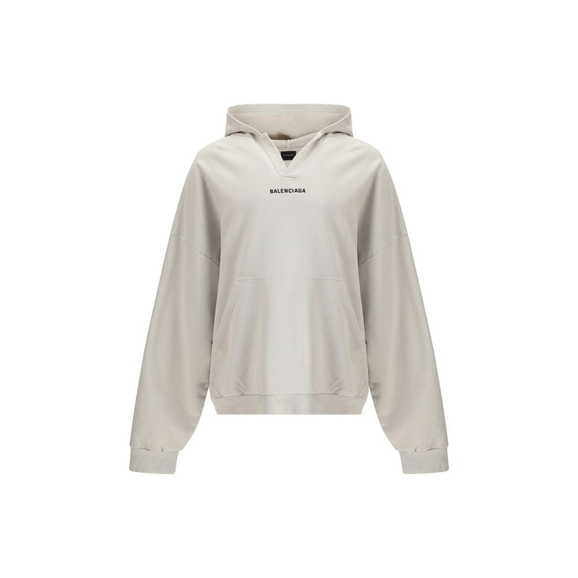 White Cotton SweatshirtThe Hoodie by Balenciaga blends comfort with iconic design. Crafted from medium fleece, it features a relaxed silhouette with dropped shoulders and a functional kangaroo pocket. Elasticated cuffs and hem ensure a defined fit, while