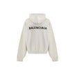 White Cotton SweatshirtThe Hoodie by Balenciaga blends comfort with iconic design. Crafted from medium fleece, it features a relaxed silhouette with dropped shoulders and a functional kangaroo pocket. Elasticated cuffs and hem ensure a defined fit, while