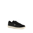 Black Leather Low Top SneakersLeather Sneakers by Prada combine contemporary style with everyday comfort. Featuring a flat rubber sole and round toe, they are distinguished by the iconic triangular side-applied plaque and tone-on-tone logo on the back, ad