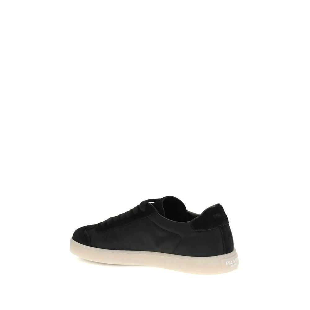 Black Leather Low Top SneakersLeather Sneakers by Prada combine contemporary style with everyday comfort. Featuring a flat rubber sole and round toe, they are distinguished by the iconic triangular side-applied plaque and tone-on-tone logo on the back, ad