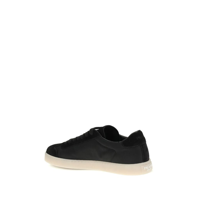Black Leather Low Top SneakersLeather Sneakers by Prada combine contemporary style with everyday comfort. Featuring a flat rubber sole and round toe, they are distinguished by the iconic triangular side-applied plaque and tone-on-tone logo on the back, ad