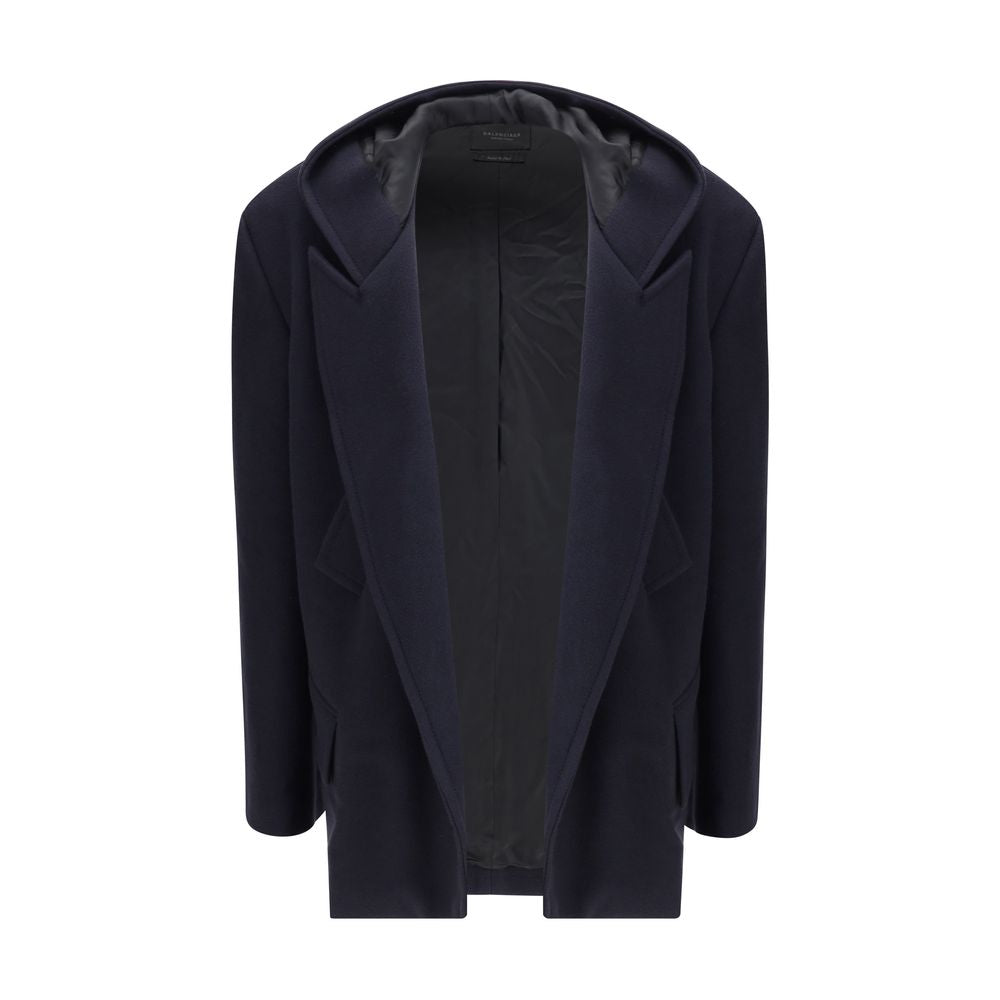 Hooded Short CoatThe hooded short Coat by Balenciaga blends tailored refinement with the brand’s contemporary edge. Crafted from dark navy brushed wool, it features a structured cut enhanced by shoulder pads and peak lapels, giving the silhouette a bold p