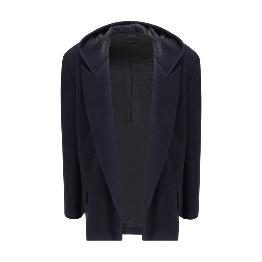 Hooded Short CoatThe hooded short Coat by Balenciaga blends tailored refinement with the brand’s contemporary edge. Crafted from dark navy brushed wool, it features a structured cut enhanced by shoulder pads and peak lapels, giving the silhouette a bold p