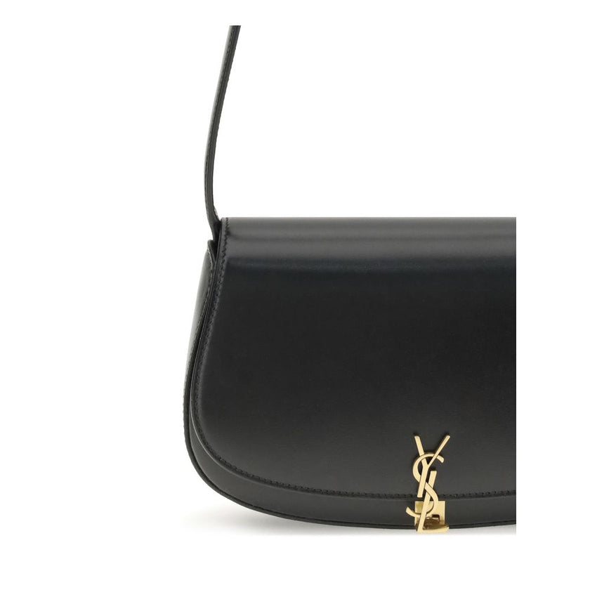 Black Calf Leather Bos Taurus Shoulder BagThe Voltaire mini Shoulder Bag by Saint Laurent is an elegant crescent-shaped bag crafted from calfskin with a lightly polished finish. Bronze-colored metallic parts add a warm, vintage touch, while the Cassandre
