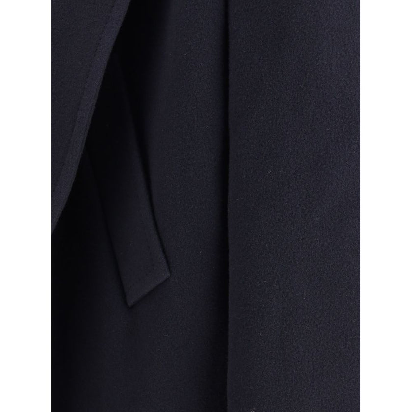 Hooded Short CoatThe hooded short Coat by Balenciaga blends tailored refinement with the brand’s contemporary edge. Crafted from dark navy brushed wool, it features a structured cut enhanced by shoulder pads and peak lapels, giving the silhouette a bold p