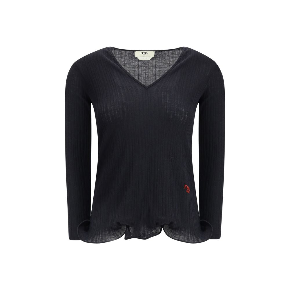 Black Fleece Wool TopThe long-sleeved Virgin Wool top by Fendi is an essential piece that combines refined simplicity with iconic details. Crafted from ribbed virgin wool, it features a fitted cut with a V-neckline, enhancing the silhouette with minimal e