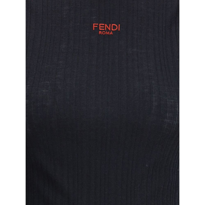 Black Wool TopThe sleeveless Virgin Wool Top by Fendi is a timeless piece that blends refined simplicity with iconic details. Crafted from ribbed Virgin Wool, it features a fitted silhouette with a high neck, enhancing the figure with understated elegance