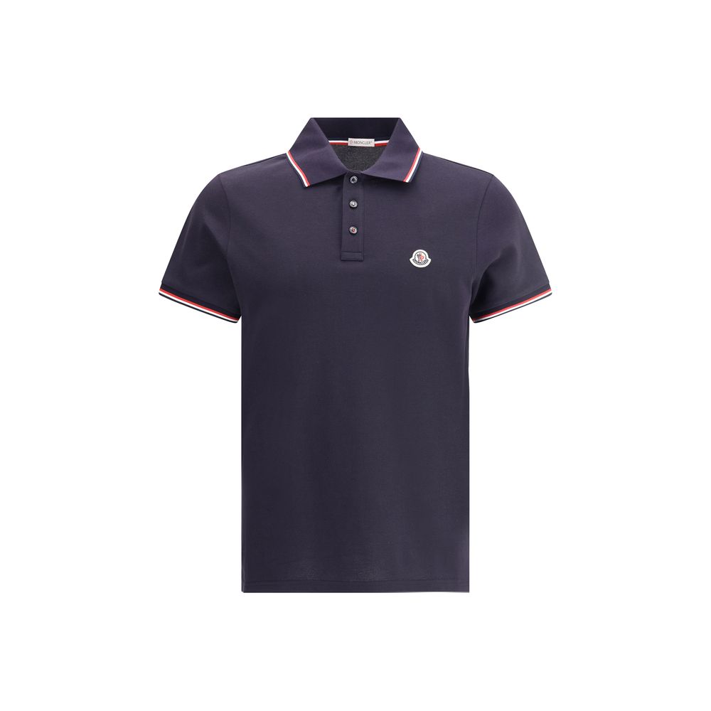 Polo shirtThe cotton piqué polo shirt by Moncler is a timeless classic that deserves a place in every wardrobe. Crafted from organic cotton, it combines comfort and sustainability with a clean, versatile style. The tricolor knit collar and cuffs add a dis