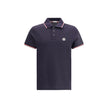 Polo shirtThe cotton piqué polo shirt by Moncler is a timeless classic that deserves a place in every wardrobe. Crafted from organic cotton, it combines comfort and sustainability with a clean, versatile style. The tricolor knit collar and cuffs add a dis