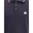 Polo shirtThe cotton piqué polo shirt by Moncler is a timeless classic that deserves a place in every wardrobe. Crafted from organic cotton, it combines comfort and sustainability with a clean, versatile style. The tricolor knit collar and cuffs add a dis