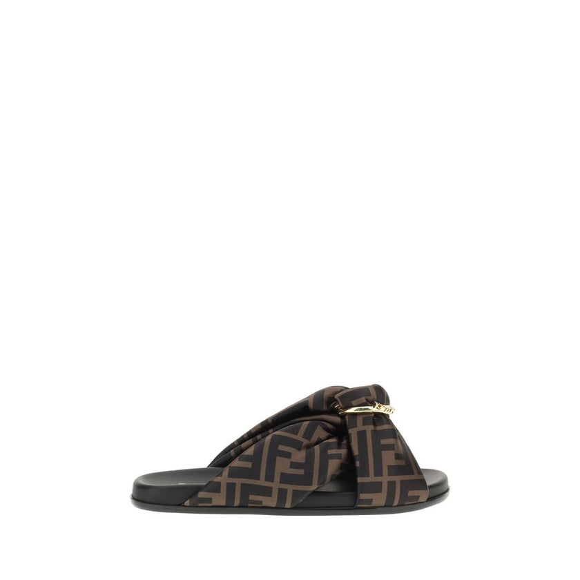 Satin Slide SandalsFendi’s Satin Slide Sandals combine elegance and comfort with their flat sole and silk upper, decorated with the brand’s distinctive FF pattern. The application of a gold Fendi signature ring adds a touch of luxury and sophistication. T