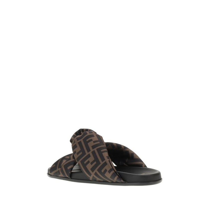 Satin Slide SandalsFendi’s Satin Slide Sandals combine elegance and comfort with their flat sole and silk upper, decorated with the brand’s distinctive FF pattern. The application of a gold Fendi signature ring adds a touch of luxury and sophistication. T