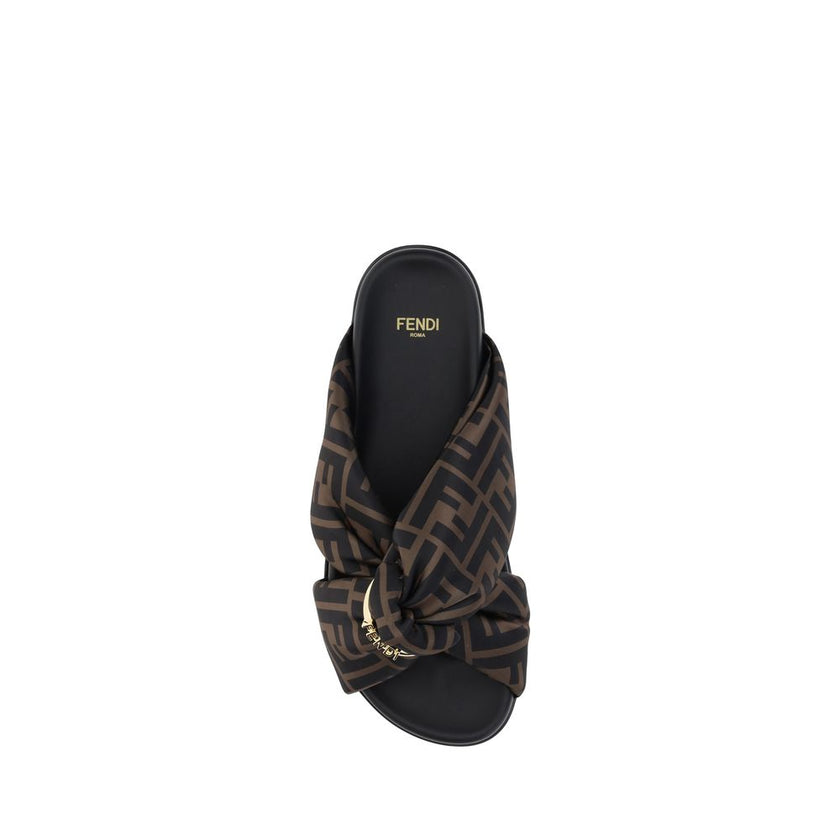 Satin Slide SandalsFendi’s Satin Slide Sandals combine elegance and comfort with their flat sole and silk upper, decorated with the brand’s distinctive FF pattern. The application of a gold Fendi signature ring adds a touch of luxury and sophistication. T