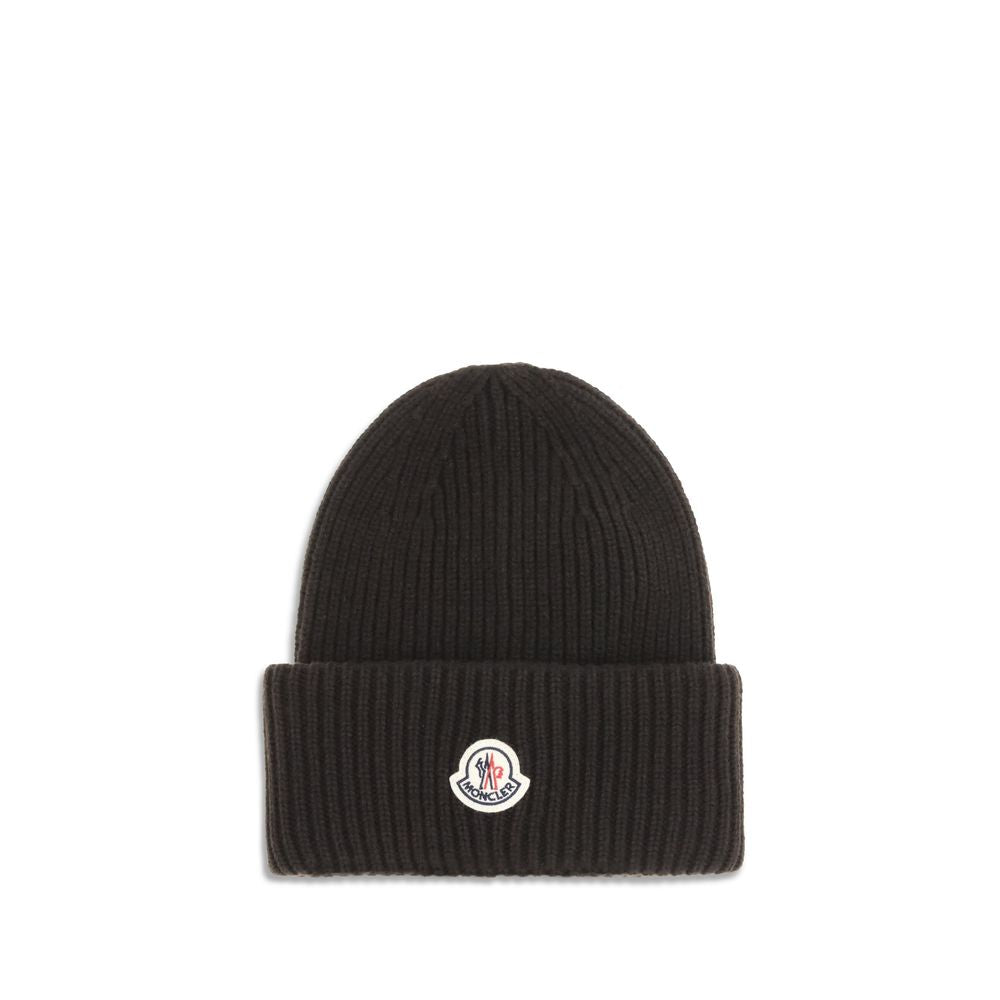 Black Wool BeanieThe beanie Hat by Moncler is crafted from a wool and cashmere blend with a brioche stitch that enhances its softness and style. The heavy knit ensures warmth and comfort, while the iconic felt patch on the front adds a distinctive and rec