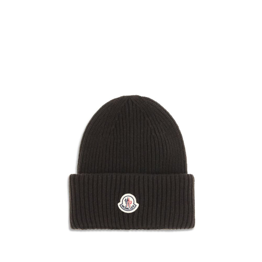 Black Wool BeanieThe beanie Hat by Moncler is crafted from a wool and cashmere blend with a brioche stitch that enhances its softness and style. The heavy knit ensures warmth and comfort, while the iconic felt patch on the front adds a distinctive and rec