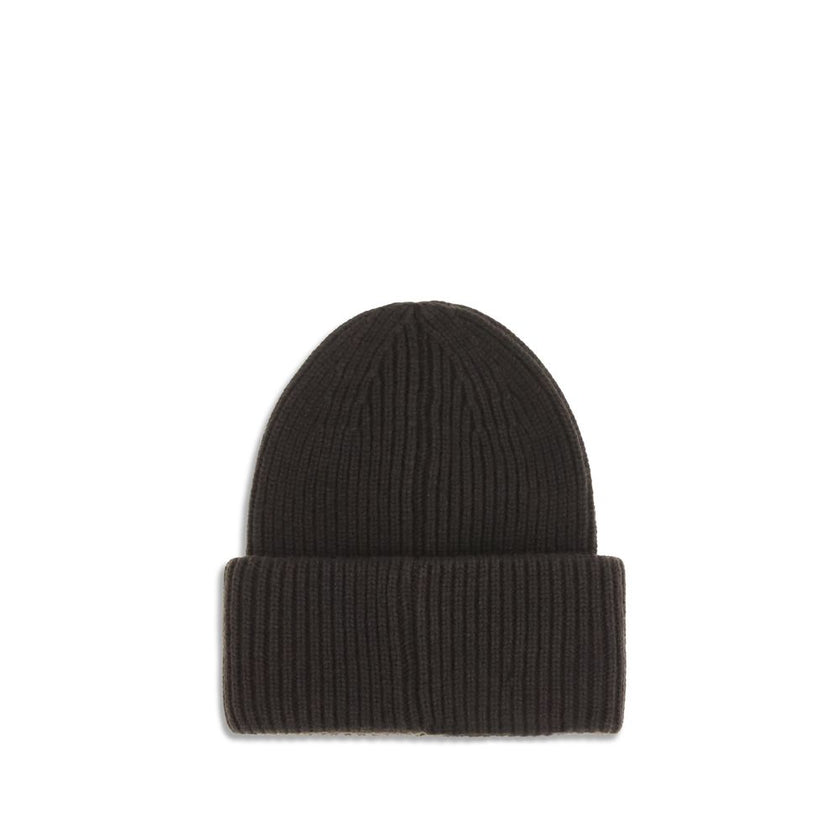 Black Wool BeanieThe beanie Hat by Moncler is crafted from a wool and cashmere blend with a brioche stitch that enhances its softness and style. The heavy knit ensures warmth and comfort, while the iconic felt patch on the front adds a distinctive and rec