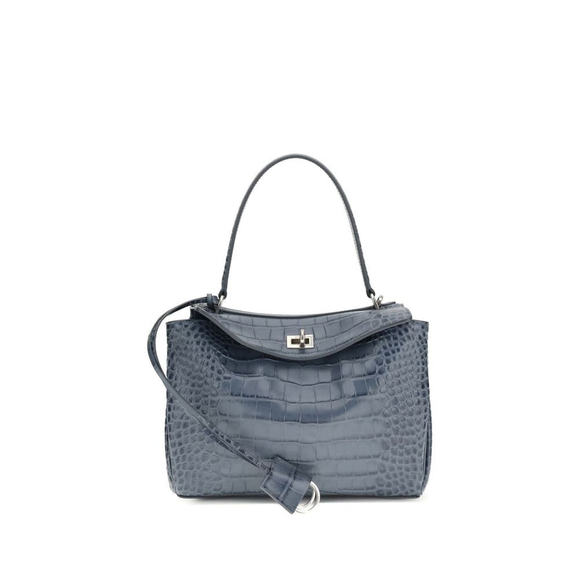 Light Blue Calf Leather Bos Taurus HandbagSmall Rodeo Handbag by Balenciaga is a structured and refined model made of calfskin with crocodile-effect processing. Equipped with a top handle and removable shoulder strap, it features iconic details such as a