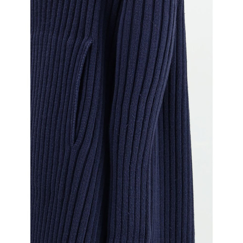 Blue Polyester Full-Length JacketThe Ribbed Shawl-Collar Cardigan by Balenciaga embodies understated luxury with its elongated silhouette and distinctive textural depth. Crafted in ribbed knit, it wraps the body with fluid ease, while the generous shawl c