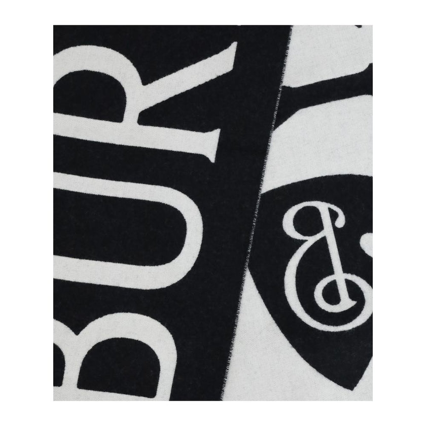Black Wool ScarfWool logo Scarf by Burberry is a refined accessory with a graphic, contemporary style. Made in Italy from soft two-tone wool, it is decorated with Burberry lettering and the B Shield jacquard pattern, inspired by the iconic Equestrian Knig