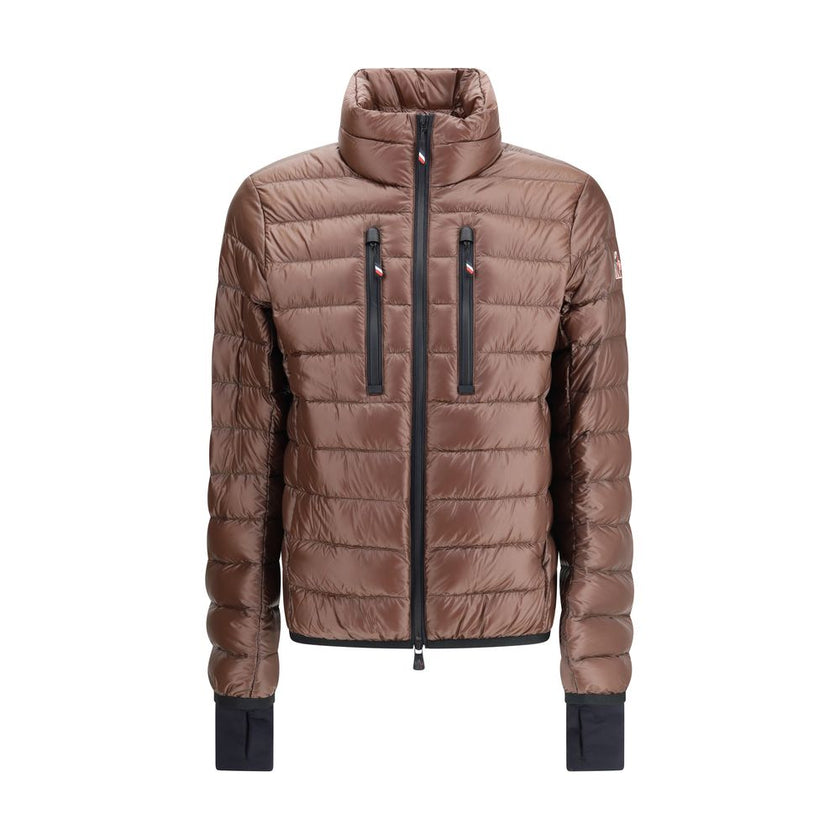 Brown Polyamide CoatThe Hers Jacket by Moncler Grenoble is a lightweight and functional piece designed to provide protection and practicality for any outdoor activity. Made from technical nylon, it features a high collar and a double-slider front zip with
