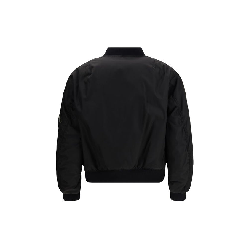 Black Polyamide BomberThe Prada Re-Nylon Bomber redefines a timeless silhouette with the house’s innovative sustainable fabric. Featuring a front zip closure, long sleeves with a classic utility-style zip pocket, and two side flap pockets, it combines fun