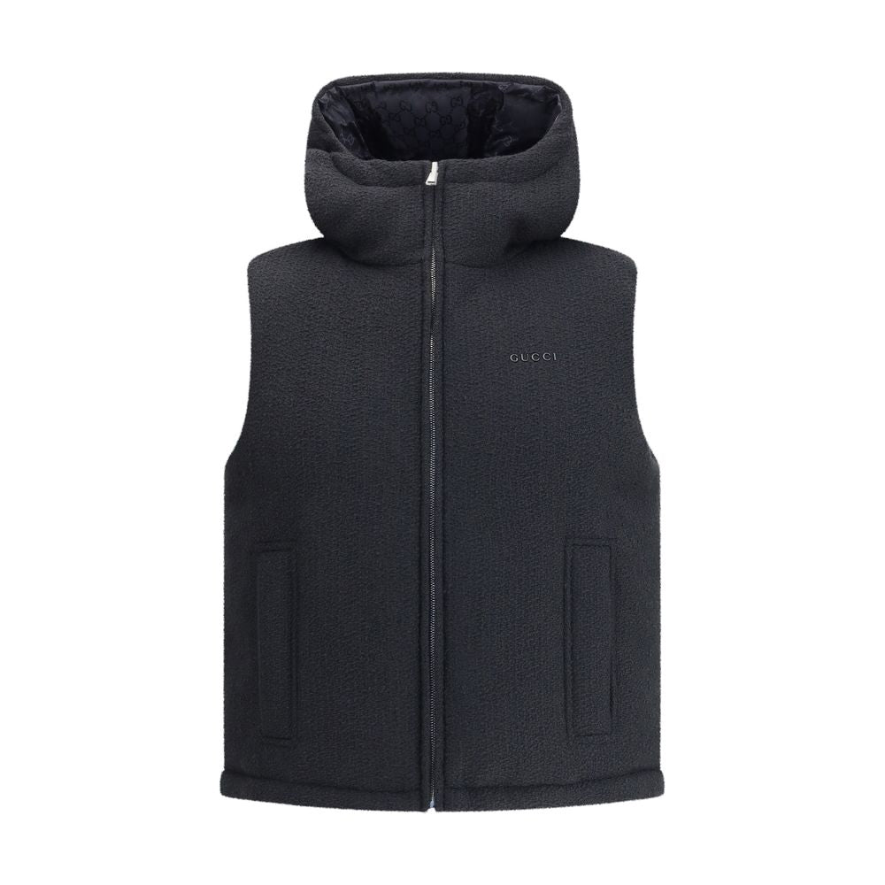 Black Wool Sleveless JacketThe Reversible Bouclé Wool Gilet by Gucci fuses practicality with contemporary elegance. One side showcases the rich texture of black bouclé wool, while the other reveals nylon detailed with the iconic GG motif, offering two dis