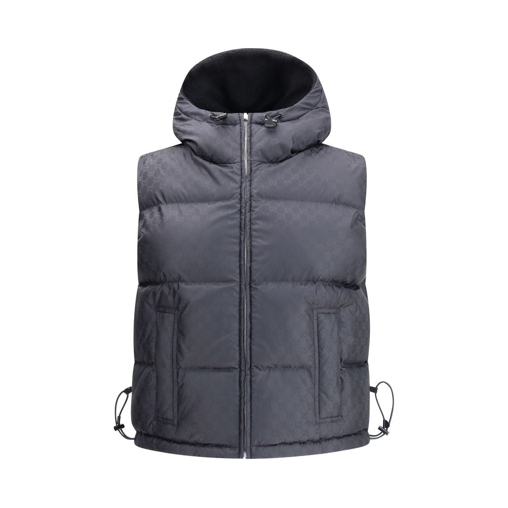 Black Wool Sleveless JacketThe Reversible Bouclé Wool Gilet by Gucci fuses practicality with contemporary elegance. One side showcases the rich texture of black bouclé wool, while the other reveals nylon detailed with the iconic GG motif, offering two dis