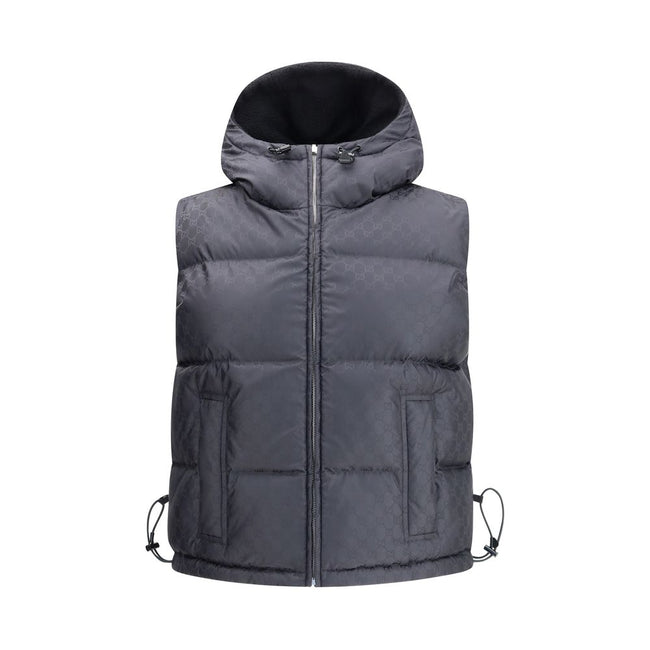 Black Wool Sleveless JacketThe Reversible Bouclé Wool Gilet by Gucci fuses practicality with contemporary elegance. One side showcases the rich texture of black bouclé wool, while the other reveals nylon detailed with the iconic GG motif, offering two dis