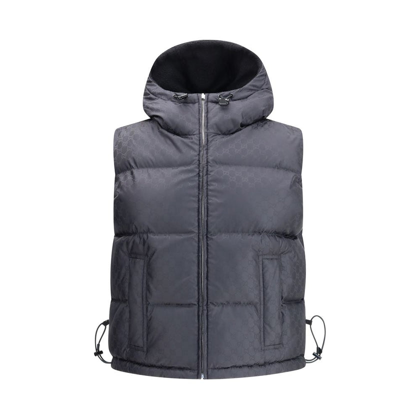 Black Wool Sleveless JacketThe Reversible Bouclé Wool Gilet by Gucci fuses practicality with contemporary elegance. One side showcases the rich texture of black bouclé wool, while the other reveals nylon detailed with the iconic GG motif, offering two dis