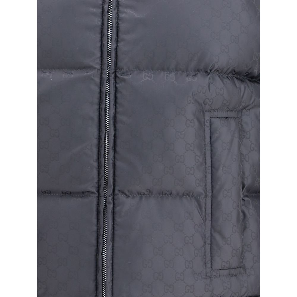 Black Wool Sleveless JacketThe Reversible Bouclé Wool Gilet by Gucci fuses practicality with contemporary elegance. One side showcases the rich texture of black bouclé wool, while the other reveals nylon detailed with the iconic GG motif, offering two dis