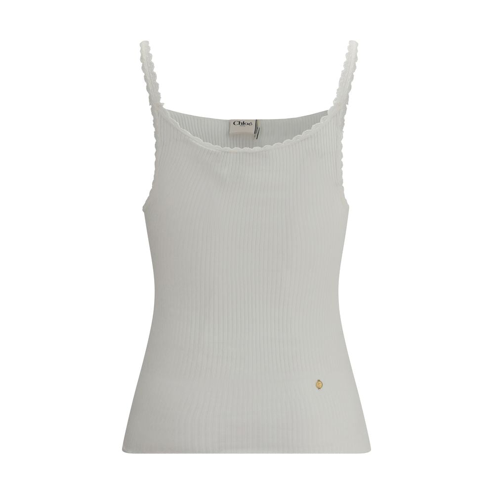 White Cotton TopThe Cotton Tank Top by Chloé channels feminine elegance through fluid and refined lines. Its lightweight silhouette is enhanced by tailored finishes and a golden medal detail on the side, a signature touch of the maison. With its essential