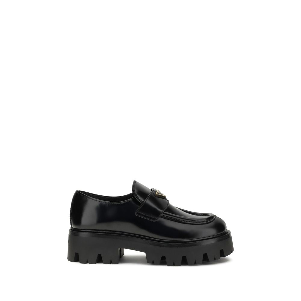 Black Calf Leather Bos Taurus Platform LoafersBrushed leather Monolith Loafers by Prada reinterpret a classic with a bold, contemporary twist. Featuring a leather horsebit upper with metallic detail, they have a burlotto bowl and an all-leather lining. Th