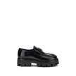 Black Calf Leather Bos Taurus Platform LoafersBrushed leather Monolith Loafers by Prada reinterpret a classic with a bold, contemporary twist. Featuring a leather horsebit upper with metallic detail, they have a burlotto bowl and an all-leather lining. Th
